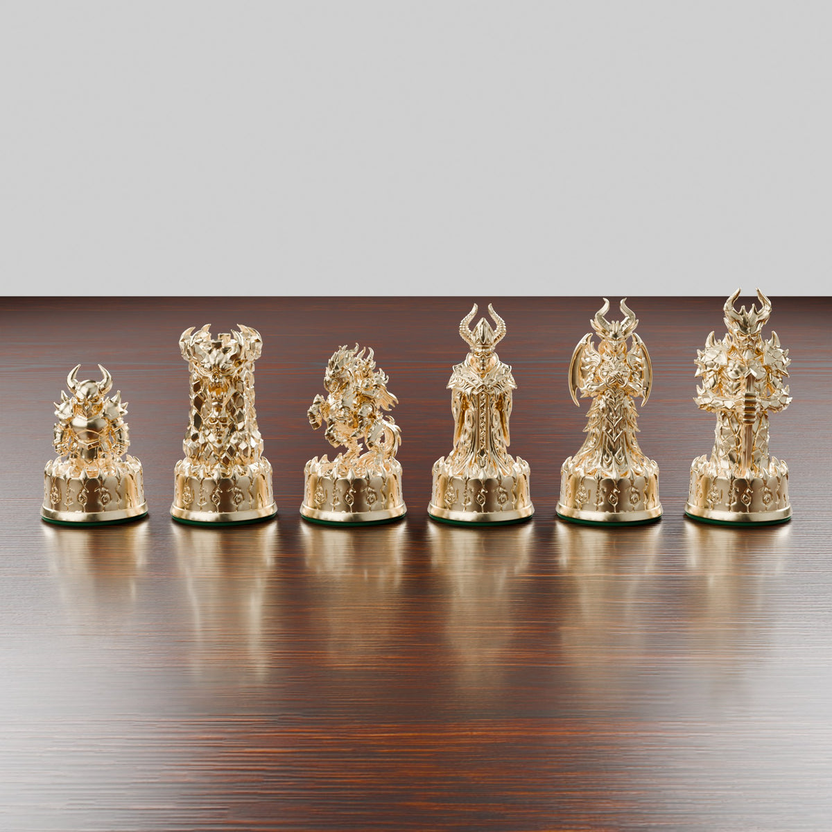 Pièces d'échecs démons finition or alignées, du pion au roi